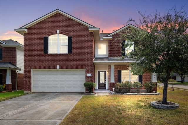 front of property featuring a lawn and a garage