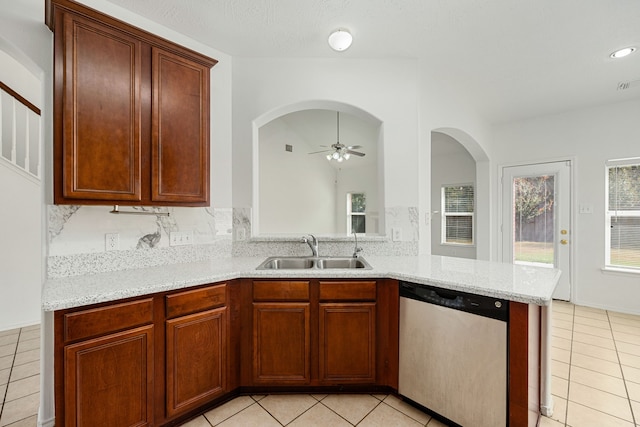 kitchen with ceiling fan, dishwasher, sink, kitchen peninsula, and light tile patterned floors