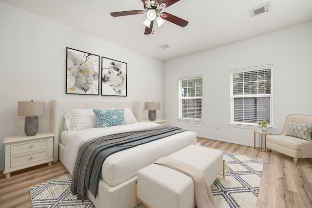 bedroom with light wood-type flooring and ceiling fan