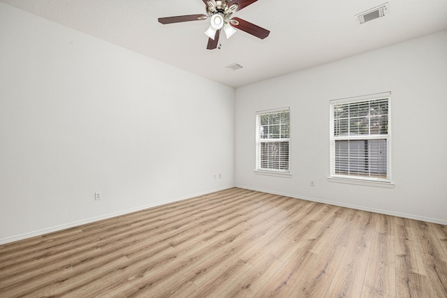 empty room featuring light wood-type flooring and ceiling fan