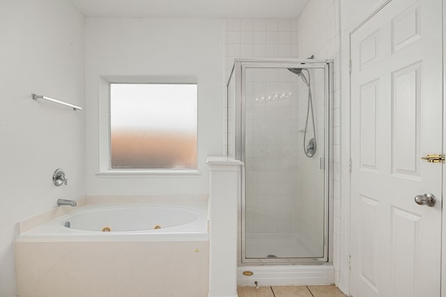 bathroom with tile patterned floors and separate shower and tub