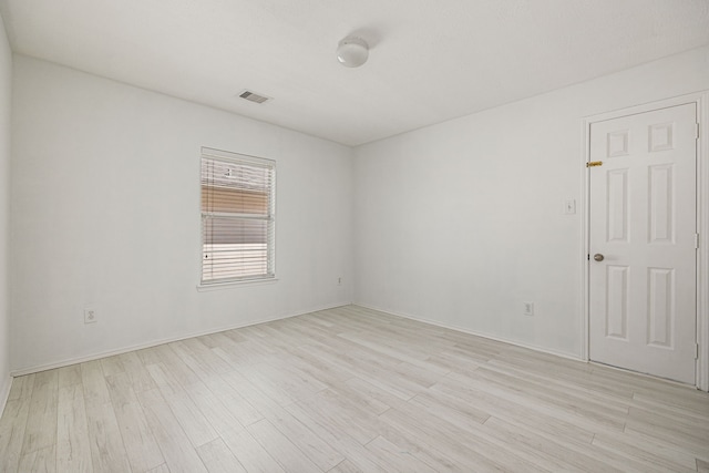 unfurnished room with light hardwood / wood-style floors