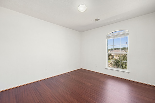 empty room with hardwood / wood-style floors