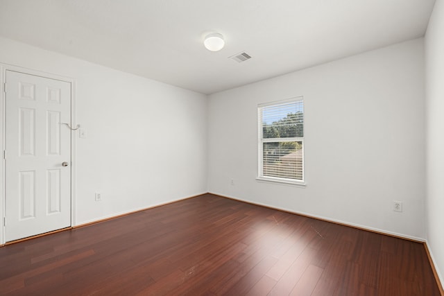 unfurnished room featuring dark hardwood / wood-style flooring