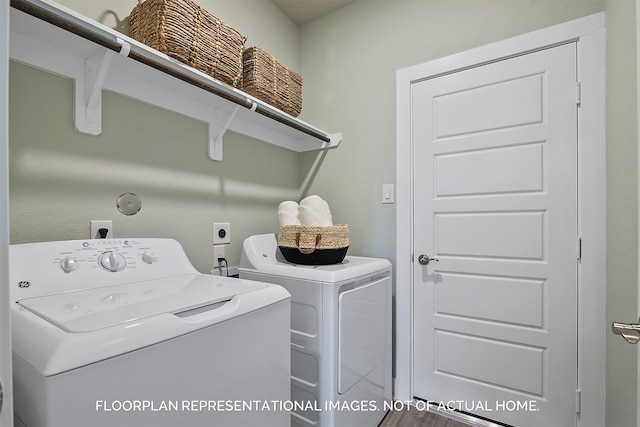 washroom with hardwood / wood-style floors and washer and dryer