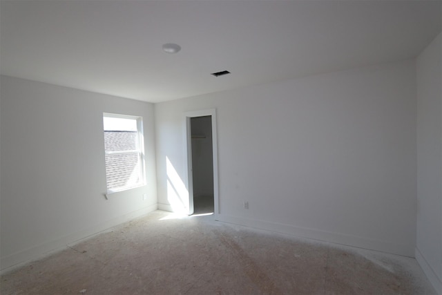 empty room featuring visible vents and baseboards