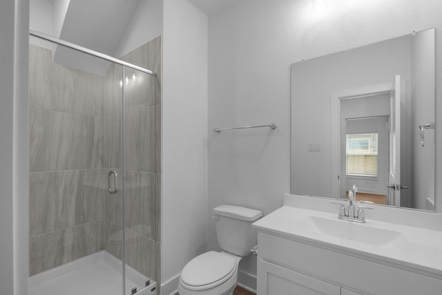 full bath with vanity, a shower stall, and toilet