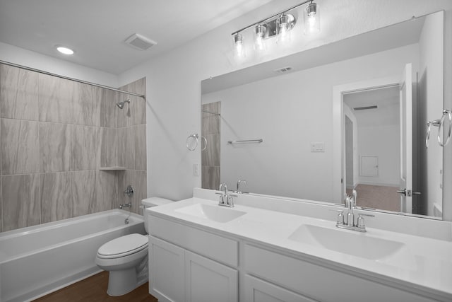 full bath featuring toilet, visible vents, shower / tub combination, and a sink