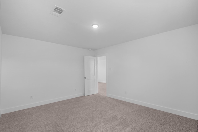 unfurnished room featuring baseboards, visible vents, and light colored carpet