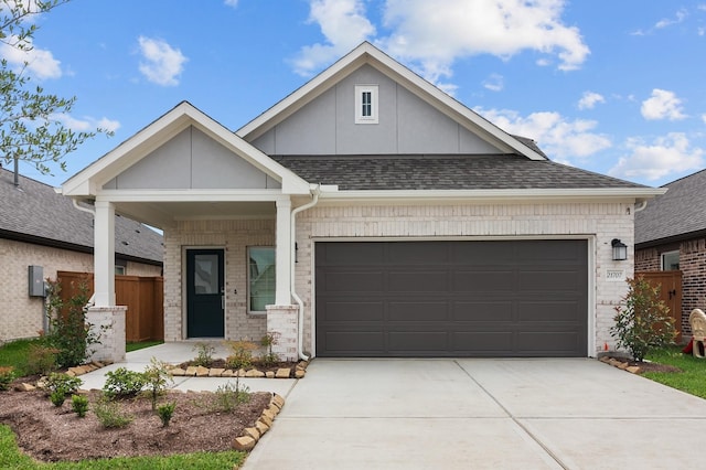 view of front of house featuring a garage, fence, roof with shingles, brick siding, and concrete driveway