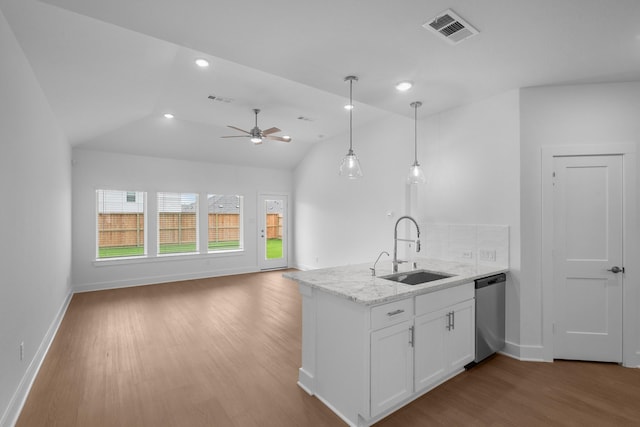 kitchen with visible vents, stainless steel dishwasher, wood finished floors, a sink, and white cabinetry