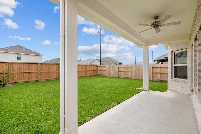 view of yard with a fenced backyard, ceiling fan, and a patio area