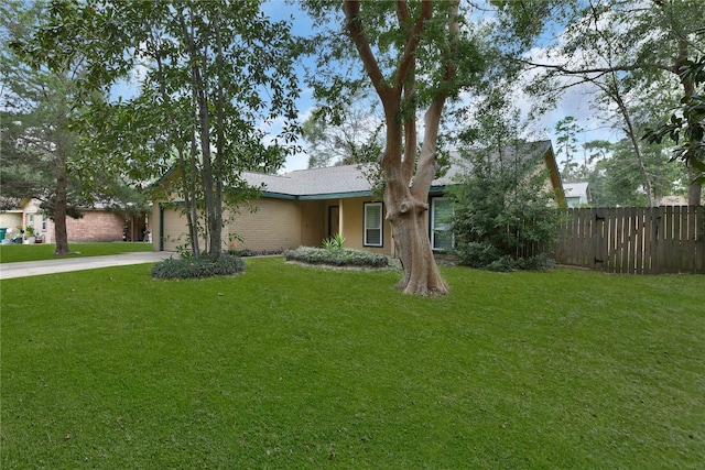 single story home with a front yard and a garage