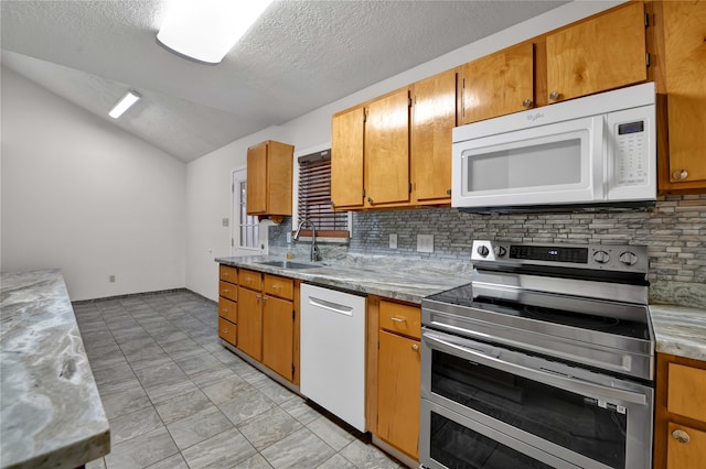 kitchen featuring tasteful backsplash, a textured ceiling, white appliances, vaulted ceiling, and sink