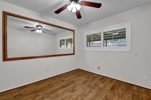 empty room featuring wood-type flooring, a textured ceiling, and ceiling fan