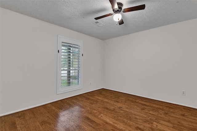 empty room with a textured ceiling, hardwood / wood-style flooring, and ceiling fan