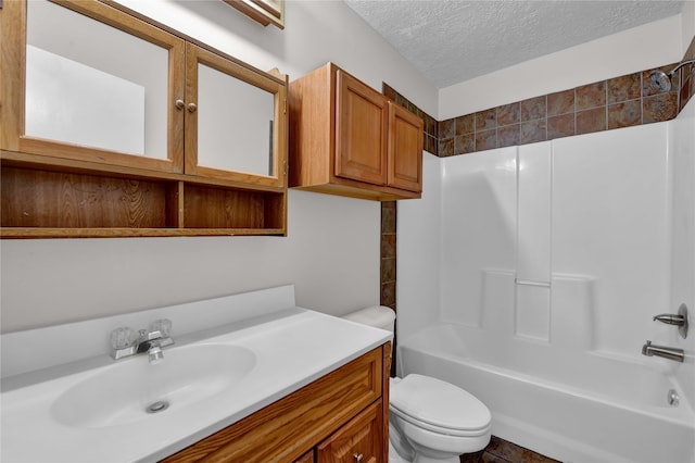 full bathroom featuring shower / bathing tub combination, vanity, toilet, and a textured ceiling