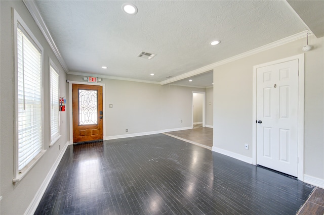 interior space featuring dark hardwood / wood-style flooring, ornamental molding, and a textured ceiling