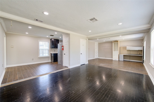 unfurnished living room with a textured ceiling, dark hardwood / wood-style floors, and crown molding