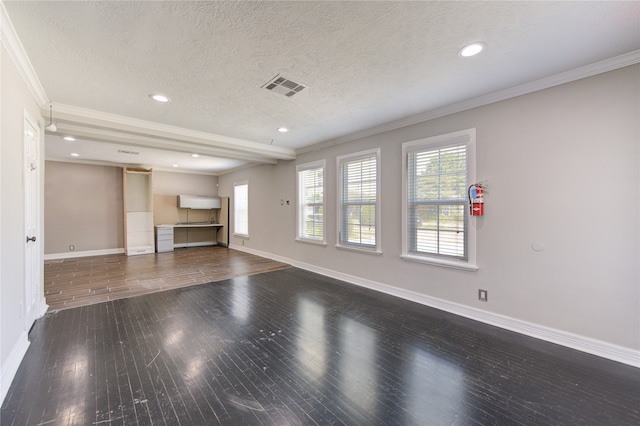 unfurnished living room with a textured ceiling, dark hardwood / wood-style flooring, and ornamental molding