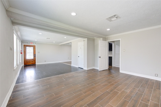 unfurnished room with dark hardwood / wood-style floors, ornamental molding, and a textured ceiling