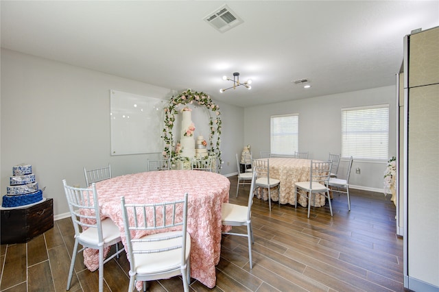 dining room featuring dark wood-type flooring and a chandelier