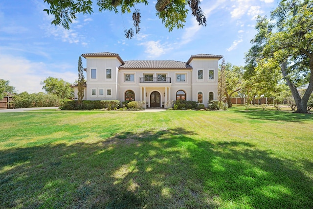 mediterranean / spanish house with a front yard