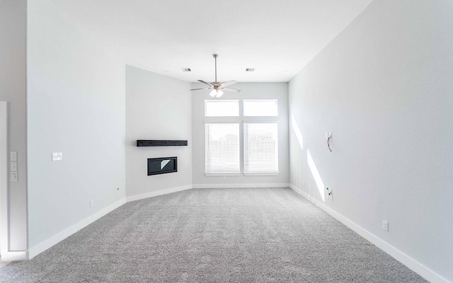 unfurnished living room with light colored carpet and ceiling fan