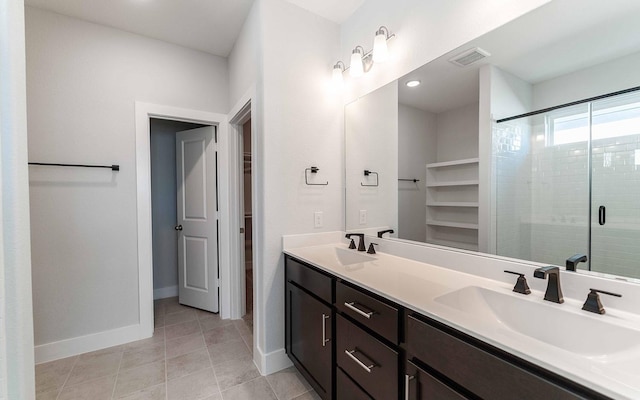 bathroom with vanity, tile patterned floors, and a shower with door