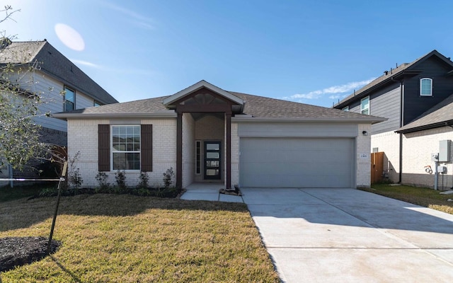 view of front of home with a garage and a front yard