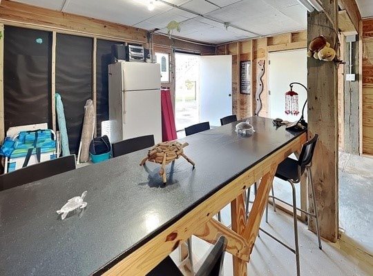 kitchen with wooden walls and white refrigerator