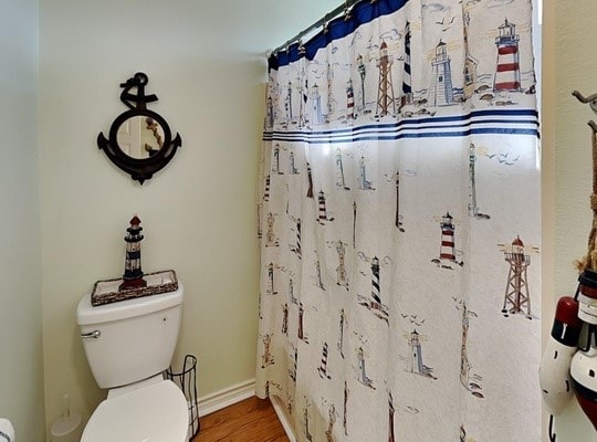 bathroom featuring hardwood / wood-style flooring and toilet