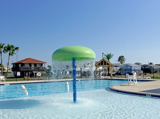 view of swimming pool with pool water feature