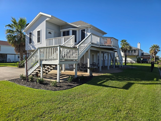 back of property with a deck and a lawn