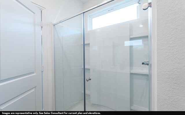 13113 Sapphire Lake Ln, Texas City, TX 77568 - full bathroom with a textured wall and a shower stall