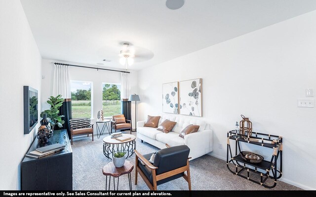 carpeted living room with ceiling fan