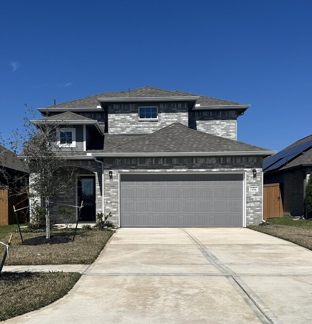 13113 Sapphire Lake Ln, Texas City, TX 77568 - view of front of property featuring concrete driveway, a garage, roof with shingles, and brick siding
