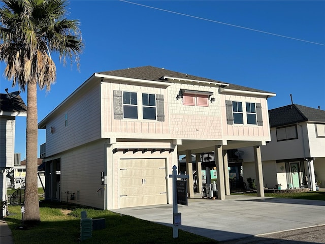 coastal home featuring a carport, concrete driveway, and a garage