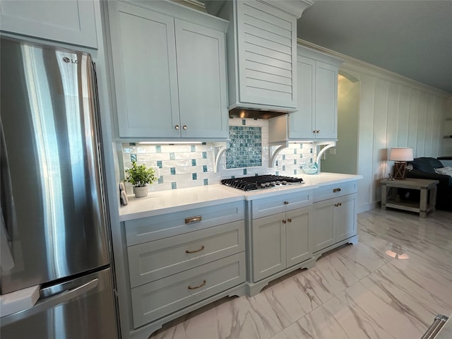 874 Bonita, Bayou Vista, TX 77563 - kitchen with appliances with stainless steel finishes, light marble finish floors, light countertops, backsplash, and arched walkways