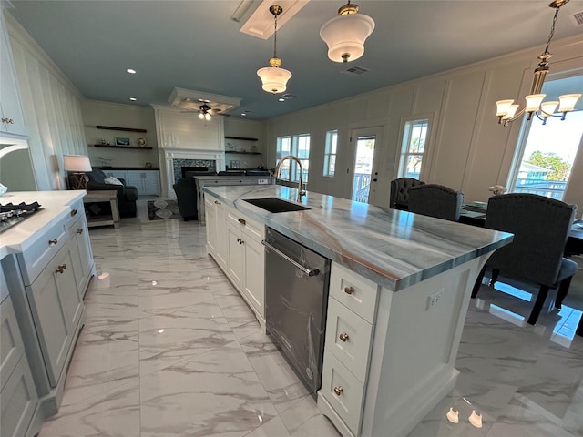 kitchen featuring pendant lighting, dishwasher, a center island with sink, white cabinets, and sink