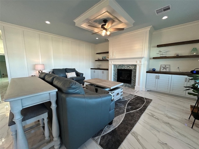 living room with ceiling fan and crown molding