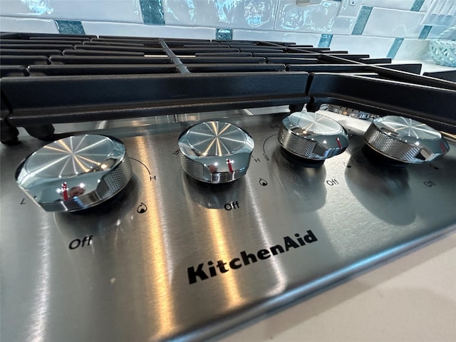 interior details featuring stovetop and backsplash