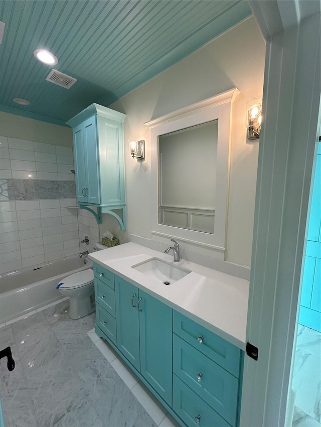 full bathroom featuring vanity, toilet, and tiled shower / bath combo