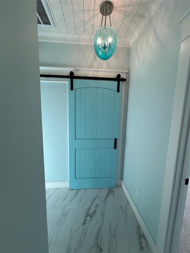 doorway to outside with a barn door and ornamental molding