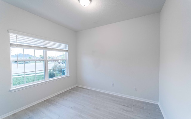 spare room featuring light hardwood / wood-style flooring