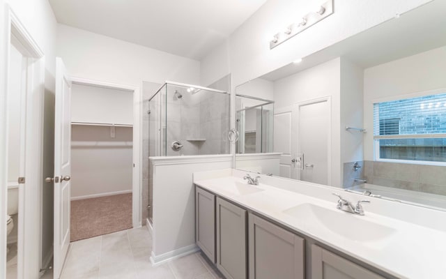 full bathroom with tile patterned flooring, vanity, toilet, and plus walk in shower