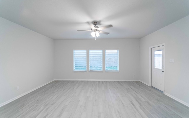 spare room featuring light hardwood / wood-style flooring, a wealth of natural light, and ceiling fan