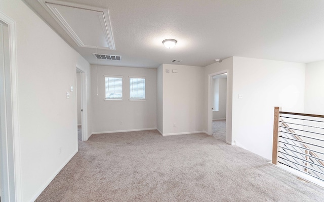 carpeted spare room with a textured ceiling