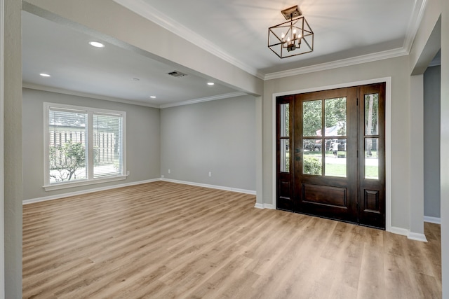 entrance foyer featuring a chandelier, light hardwood / wood-style floors, and crown molding