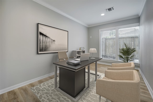 home office with light hardwood / wood-style floors and crown molding